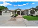 Charming single-story home with well-manicured lawn, mature landscaping, and a two-car garage at 3671 S Greythorne Way, Chandler, AZ 85248
