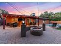 Inviting backyard with a cozy fire pit, outdoor seating, and string lights for evening entertainment at 3919 S Siesta Ln, Tempe, AZ 85282