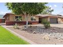 Charming home with brick accents and a well-maintained yard featuring desert landscaping for curb appeal at 3919 S Siesta Ln, Tempe, AZ 85282