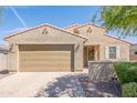 Inviting home featuring a two-car garage, desert landscaping, and a warm, neutral color scheme at 4084 E Caitlin Dr, San Tan Valley, AZ 85140
