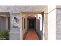 Close-up view of the home's entryway, featuring a tiled walkway and a dark-colored double front door at 6126 E Paradise Ln, Scottsdale, AZ 85254