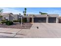 Charming home showcasing desert landscaping, a paved driveway, and a spacious two-car garage at 6126 E Paradise Ln, Scottsdale, AZ 85254