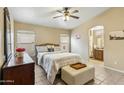 Bright bedroom with ceiling fan and access to bathroom at 6713 E Riverdale St, Mesa, AZ 85215