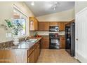 Kitchen with stainless steel appliances and wood cabinets at 6713 E Riverdale St, Mesa, AZ 85215