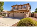 Angle shot of a two story home, highlighting the three-car garage and desert landscaping at 6967 W Potter Dr, Glendale, AZ 85308