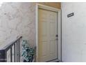 Condo entrance with a textured exterior wall, houseplant, and unit number B208 at 8055 E Thomas Rd # B208, Scottsdale, AZ 85251
