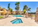 Community pool and hot tub, surrounded by lounge chairs and desert landscaping at 8055 E Thomas Rd # B208, Scottsdale, AZ 85251