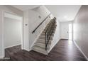 Inviting entryway with wood-look floors and a staircase with decorative wrought iron railing at 8443 E Via De Los Libros --, Scottsdale, AZ 85258