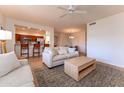 Comfortable living room with ceiling fan, open to kitchen and dining areas, with neutral decor at 8880 E Paraiso Dr # 118, Scottsdale, AZ 85255
