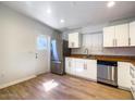 Bright kitchen features stainless appliances, wood-look floors and white cabinets at 1219 E Colter St # 8, Phoenix, AZ 85014