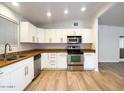 Bright kitchen features stainless appliances, wood-look floors and white cabinets at 1219 E Colter St # 8, Phoenix, AZ 85014