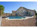 Sparkling backyard pool surrounded by desert landscaping and a secure privacy fence at 12205 N 41St Ln, Phoenix, AZ 85029