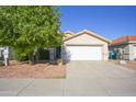 Attractive single-story home with a well-manicured front yard and attached two-car garage at 12205 N 41St Ln, Phoenix, AZ 85029