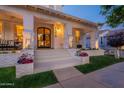 Elegant front entrance featuring decorative columns, a decorative door, and beautiful landscaping at 1379 S Claiborne Ave, Gilbert, AZ 85296