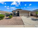 Charming one-story home with a two-car garage, desert landscaping and concrete driveway at 14625 W Redfield Rd, Surprise, AZ 85379