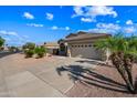 Attractive single-story home featuring desert landscaping, wide driveway, and a two-car garage at 14625 W Redfield Rd, Surprise, AZ 85379