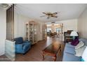 Cozy living room with hardwood floors and comfortable blue furniture at 15438 N Lakeforest Dr, Sun City, AZ 85351
