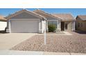 Single-level home with a front-facing two-car garage and low-maintenance desert landscaping at 2350 E Nunneley Ct, Gilbert, AZ 85296