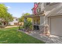 Inviting home exterior featuring a quaint front porch with decorative stone accents at 2545 E Harrison Ct, Gilbert, AZ 85295