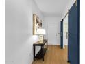 Bright entryway featuring modern decor, barn-door accent, and wood-look flooring at 2545 E Harrison Ct, Gilbert, AZ 85295