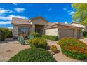 Inviting single-story home with desert landscaping, mature plants, and a covered front porch at 6428 E Nisbet Rd, Scottsdale, AZ 85254