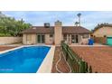 Refreshing backyard pool is surrounded by desert landscaping, perfect for relaxation and outdoor enjoyment at 702 W Sequoia Dr, Phoenix, AZ 85027
