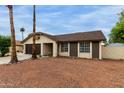 Inviting single-story home with desert landscaping, offering a serene and low-maintenance outdoor space at 702 W Sequoia Dr, Phoenix, AZ 85027
