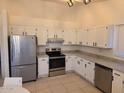 Bright kitchen features stainless steel appliances and white cabinetry at 702 W Sequoia Dr, Phoenix, AZ 85027
