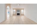Bright living room with a white brick fireplace, tile flooring, and large windows, perfect for gatherings at 702 W Sequoia Dr, Phoenix, AZ 85027