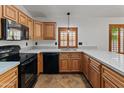 Well-appointed kitchen featuring ample counter space, stainless steel sink, and black appliances at 9852 W Salter Dr, Peoria, AZ 85382