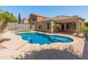 Inviting backyard pool with mature palm trees and ample patio space for entertaining or relaxing at 9852 W Salter Dr, Peoria, AZ 85382