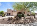 View of home with a well-kept yard, desert landscaping, and mature trees at 10939 W Meadowbrook Ave, Phoenix, AZ 85037