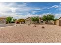 Single-story home with a three-car garage featuring low-maintenance desert landscaping and a tile roof at 11010 W Palm Ln, Avondale, AZ 85392