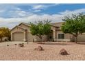 Single-story home features neutral stucco, low maintenance desert landscaping, and a convenient three-car garage at 11010 W Palm Ln, Avondale, AZ 85392