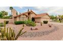 View of a single-story home with desert landscaping and a three car garage at 1139 E Stephens Dr, Tempe, AZ 85283