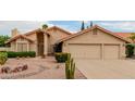 Single-story house showcasing desert landscaping with cacti, a brick entry, and a three-car garage at 1139 E Stephens Dr, Tempe, AZ 85283
