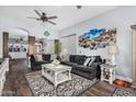 Spacious living room features an open floorplan, modern decor, and wood-style flooring at 1144 W Tremaine Ave, Gilbert, AZ 85233