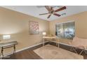 Bright bedroom features stylish decor, a ceiling fan, and a window with natural light at 14010 N 126Th Ave, El Mirage, AZ 85335