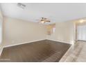 Spacious living room featuring hardwood floors and staircase access at 14010 N 126Th Ave, El Mirage, AZ 85335