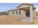 Back exterior of home featuring a covered patio and minimalist backyard landscaping at 1409 E Jacqueline Pl, Casa Grande, AZ 85122