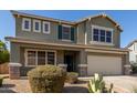 Charming two-story home featuring a well-maintained yard, desert landscaping, and a welcoming front porch at 15010 W Hope Dr, Surprise, AZ 85379