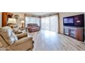 Bright living room featuring hardwood floors, large windows, and comfortable seating at 17404 N 99Th Ave # 318, Sun City, AZ 85373