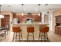 Stylish kitchen with a breakfast bar, granite countertops, and stainless steel appliances at 17797 W Statler Dr, Surprise, AZ 85388