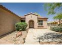 Inviting front entrance with desert landscaping and a stone walkway at 20007 N Organ Pipe Dr, Surprise, AZ 85374