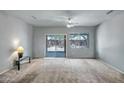 Bright, open living room with a sliding door leading to the backyard at 20007 N Organ Pipe Dr, Surprise, AZ 85374