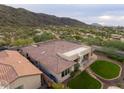 An aerial view of a desert home featuring a private yard, patio, and mountain views at 2106 E Beth Dr, Phoenix, AZ 85042