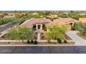 Aerial view of a single-story home featuring desert landscaping, tile roof, and three-car garage at 2106 E Beth Dr, Phoenix, AZ 85042