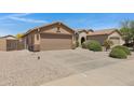 Single story home with low maintenance desert landscaping, two-car garage, and tile roof at 2318 W Kristina Ave, San Tan Valley, AZ 85144