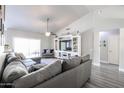 Bright open-concept living room with modern furniture and neutral tones at 238 W Marco Polo Rd, Phoenix, AZ 85027