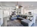 Open-concept living area with a gray sectional, ceiling fan, and modern décor at 238 W Marco Polo Rd, Phoenix, AZ 85027